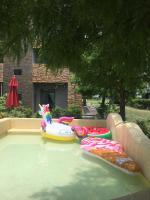 a swimming pool with three inflatable toys in it at Muho B&amp;B in Dongshan