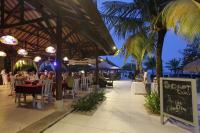 a restaurant on the beach with people sitting at tables at Peninsula Beach Resort in Nusa Dua