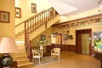 a living room with a staircase and chairs at Castellu Rossu in Lucciana