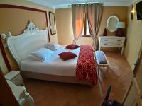 a bedroom with a large white bed with red pillows at Bastide De Mazan in Riez