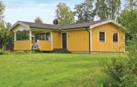 a small yellow house with a yard at Awesome Home In Broaryd With 2 Bedrooms in Bohult
