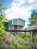 a green house on top of a hill at Björkbackens Stugby i Vimmerby in Vimmerby