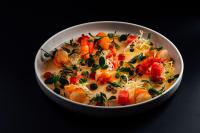 a bowl of food with shrimp and vegetables on a table at Hotel-Restaurant Bellevue in Flims