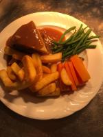 a plate of food with meat and french fries and gravy at The Old Pound Inn in Langport