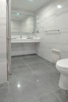 a bathroom with a toilet and a sink and a mirror at Artezen Hotel in New York