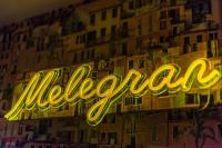 a neon sign in front of a building at The Melegran in Rovinj