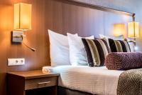Een bed of bedden in een kamer bij Hotel Amstelzicht
