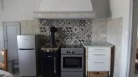 a kitchen with a stove and a refrigerator at Maison de Romagers in Aumont-Aubrac