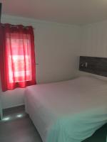 a bedroom with a white bed and a red window at Fasthotel Albertville in Albertville