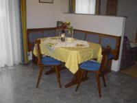 a dining room table with a yellow table cloth and blue chairs at Appartement Pichler in Radstadt