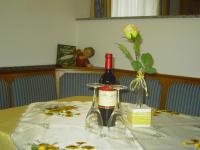 a table with two bottles of wine and a flower at Appartement Pichler in Radstadt