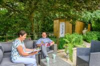 a man and a woman sitting on a couch at B&amp;B Au bois dormant chambres d hotes in Tillé