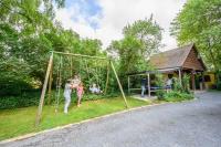 a woman and two children playing on a swing at B&amp;B Au bois dormant chambres d hotes in Tillé