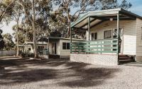 a white house with a green and white porch at G&#39;Day Parks Ararat in Ararat