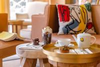 a table with a cup of coffee and a cupcake on it at 9Confidentiel in Paris