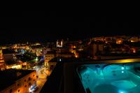 a view of a city at night with lights at Penthouse Retreat in Cospicua