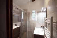 a bathroom with a shower and a sink and a tub at Le Clos Zinou in Lambesc