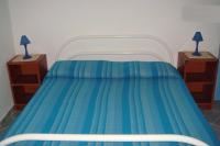 A bed or beds in a room at On The Beach La Rena Beddha