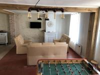 a living room with a pool table in the middle of it at Maison de ville 3 chambres 3 salles d&#39;eau parking 2 places in Romorantin