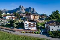 a village with houses and mountains in the background at Apartments Sayonara in Castelrotto