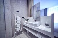 a white bathroom with a sink and a mirror at Maison Nô - Hôtel et Rooftop in Lyon