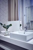 a bathroom with a white sink and a mirror at Maison Nô - Hôtel et Rooftop in Lyon