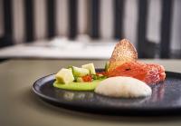 a plate of food with meat and vegetables on a table at Maison Nô - Hôtel et Rooftop in Lyon