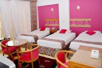 A bed or beds in a room at Marhaba Palace Hotel