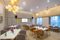 a conference room with tables and chairs and chandeliers at Citadines Keqiao Shaoxing in Shaoxing