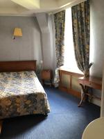 a hotel room with a bed and a window at LE CABOUILLET in LʼIsle-Adam