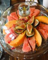 a glass plate filled with fruit on a table at LES CHAMBRES D&#39;HOTES DU PALAIS in Douai