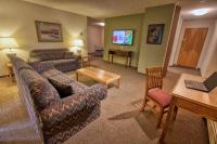 a living room with a couch and a table at Wedgewood Resort in Fairbanks