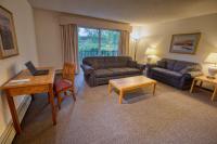 a living room with a couch and a table at Wedgewood Resort in Fairbanks