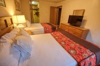 a hotel room with two beds and a flat screen tv at Wedgewood Resort in Fairbanks