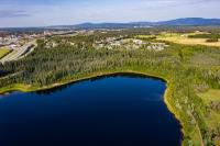 an aerial view of a lake with trees and houses at Wedgewood Resort in Fairbanks