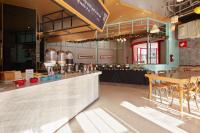 a restaurant with a counter with a table and chairs at Hotel 7 Taichung in Taichung