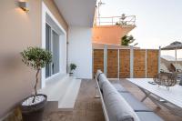 a balcony with a bench and a table on a building at Valtes Luxurious Apartments in Mpoukaris