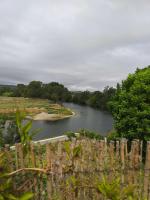 a view of a river from a fence at Riverside Home Cottage in Trèbes