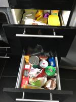 an open refrigerator drawer filled with food and drinks at Résidence des trois pins in Plomeur