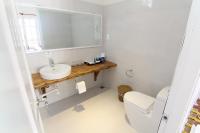 a bathroom with a sink and a toilet and a mirror at Peppercorn Beach Resort in Phú Quốc
