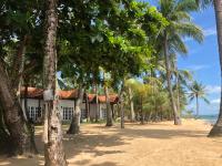 a house on the beach with palm trees at Peppercorn Beach Resort in Phú Quốc