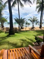 a park with benches and palm trees on the beach at Peppercorn Beach Resort in Phú Quốc