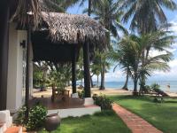 a house with a porch with a view of the beach at Peppercorn Beach Resort in Phú Quốc