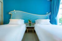 Postel nebo postele na pokoji v ubytování Centara Sonrisa Residences & Suites Sriracha