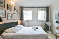 a bedroom with a bed with white sheets and a window at Cozy studio 10 min from Eiffel Tower Invalides Beaugrenelle in Paris