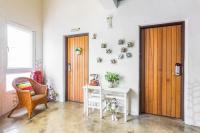 a room with a door and a table and a chair at Fairyland &amp; Farm Guest House in Kenting