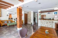 a living room with a table and chairs at Fairyland &amp; Farm Guest House in Kenting