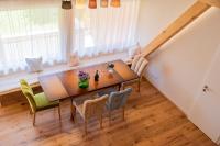 a dining room with a wooden table and chairs at Teichwiesn in Sankt Stefan ob Stainz