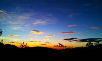 a sunset with a blue and orange sky with clouds at Jun Yue Hanging Garden Resort in Ren&#39;ai