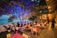 a restaurant on the beach with people sitting at tables at Samed Grandview Resort in Ko Samed